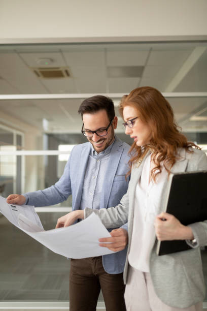Business people working together in modern office hall.
